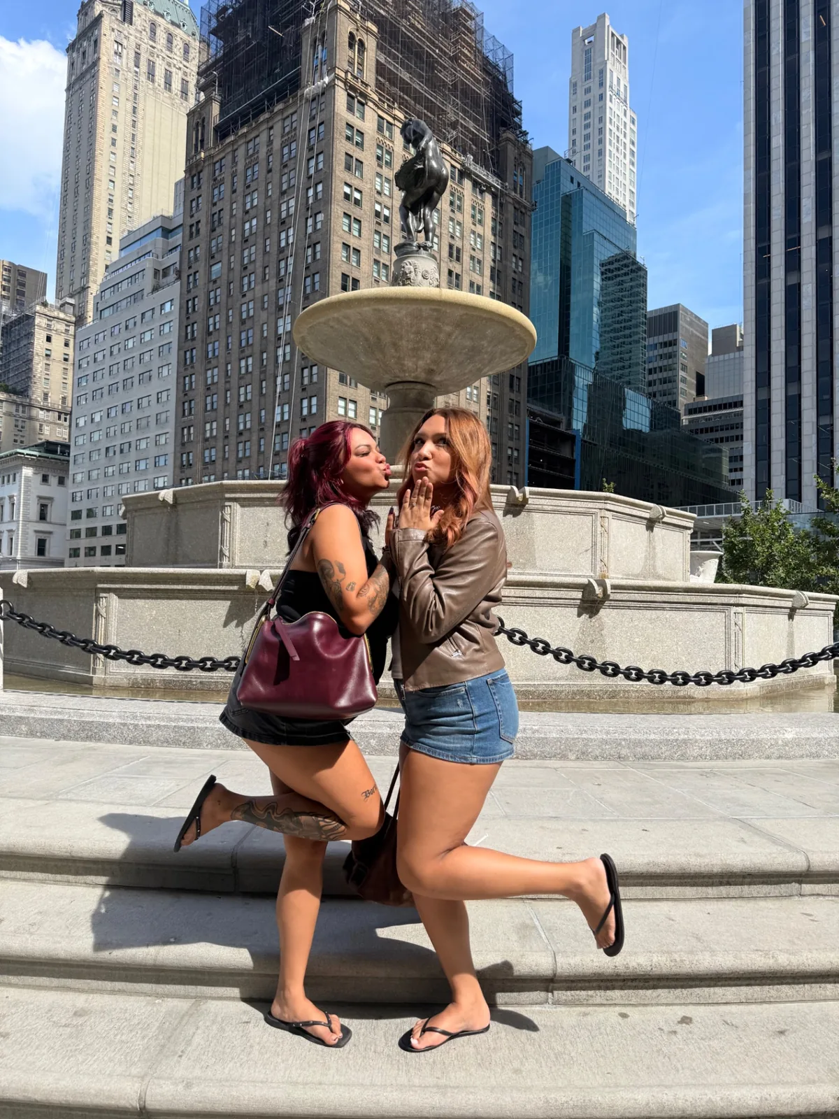 Gossip Girl Tours guests recreating the Serena and Blair photoshoot pose at Pulitzer Fountain in NYC
