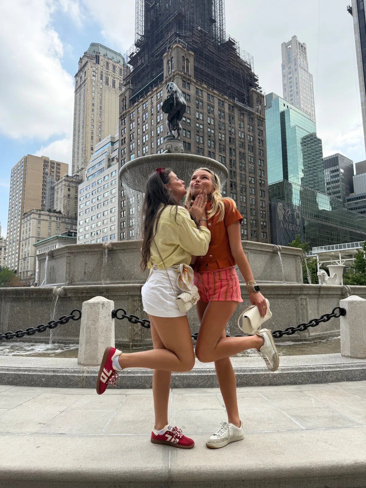 Two Gossip Girl Tours guests recreating Serena and Blair's pose at Pulitzer Fountain, Grand Army Plaza