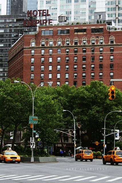 The Empire Hotel building exterior daytime with yellow cabs - Gossip Girl New York City landmark Upper West Side