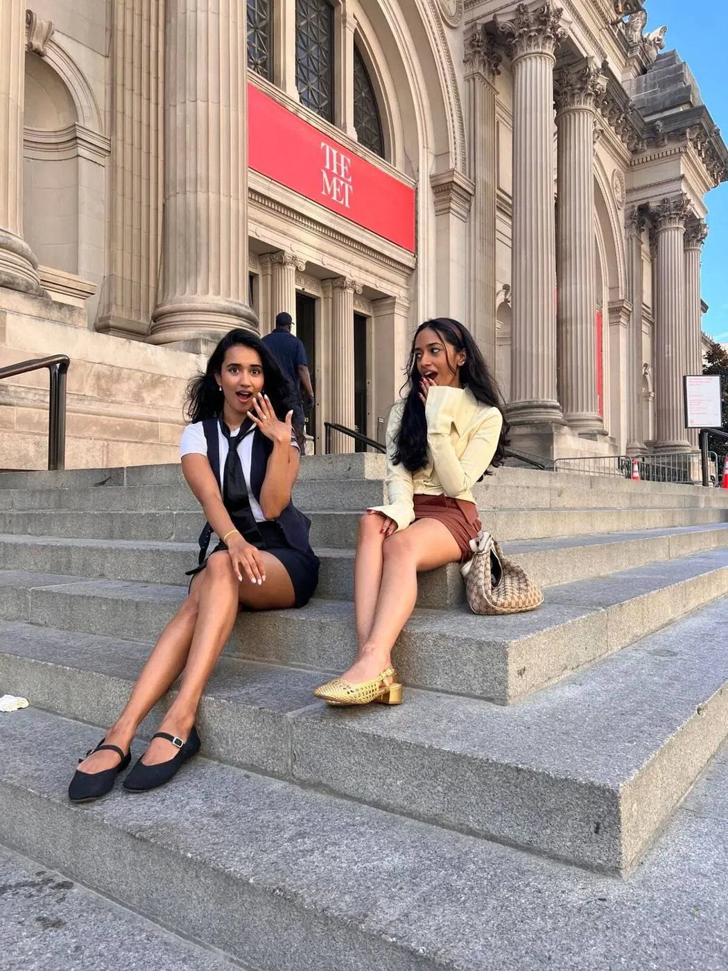 Two friends doing the Gossip Girl shocked pose on The Met Steps NYC