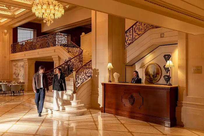 The Plaza Hotel grand lobby staircase and concierge - Gossip Girl luxury hotel filming location NYC