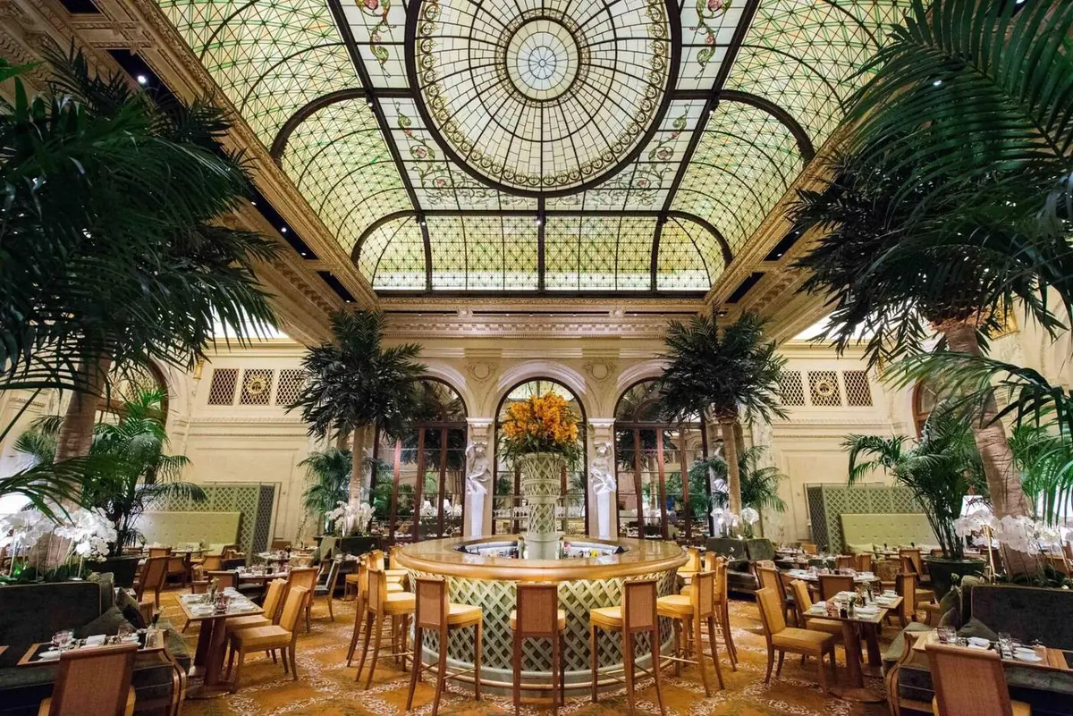 The Plaza Hotel Palm Court interior with stained glass ceiling and palm trees - Gossip Girl elite dining location