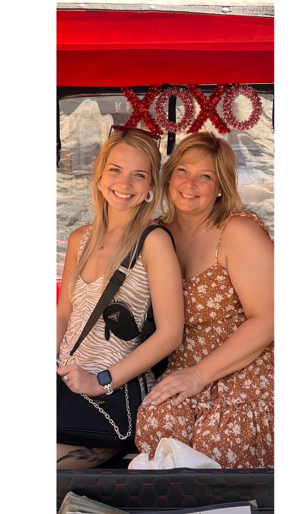 Two Gossip Girl Tours guests in a red pedicab decorated with an XOXO sign in New York City